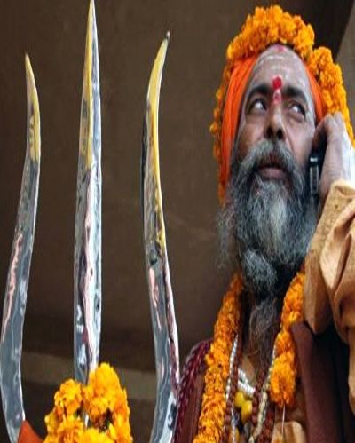 A sadhu is seen talking on a mobile phone in Varanasi.