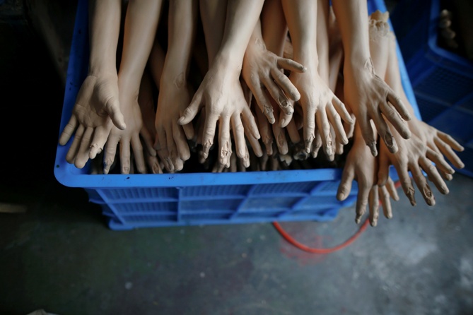 Workers make stuffed dolls which are to exported to Europe and north America, at a factory in Lianyungang, Jiangsu province, China.