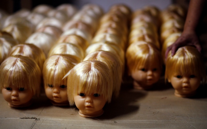 Workers make stuffed dolls which are to exported to Europe and north America, at a factory in Lianyungang, Jiangsu province, China.