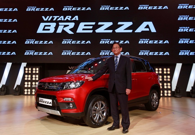 Kenichi Ayukawa, Managing Director and CEO of Maruti Suzuki India Ltd., poses with the newly launched Vitara Brezza car in Mumbai, March 8, 2016.