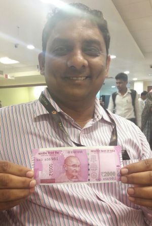 Posing with new Indian currency