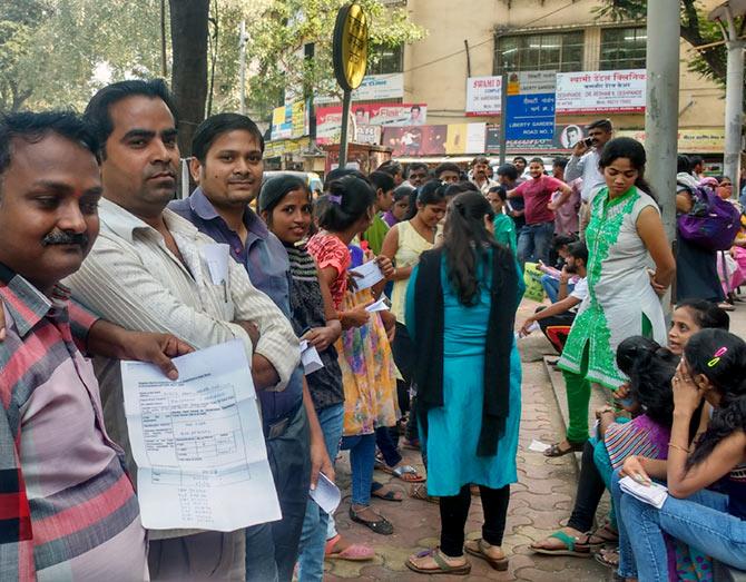 Raksha Ram (extreme left) with his friends had taken a day off to help his family, cope with shortage of liquid money that the ban has created temporarily.