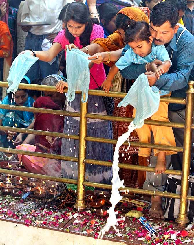 Kashmiri Pandits pour milk into a sacred well during an annual Hindu festival at a shrine in Khirbhawani, 30 km (19 miles) east of Srinagar, June 15, 2005. Thousands of displaced Kashmiri Hindus, known as Pandits in Kashmir, gathered at a holy shrine in the restive Indian state of Jammu and Kashmir on Wednesday to pray for peace and early return home. More than 200,000 Hindus fled their homes when an armed rebellion broke out in the Himalayan region nearly 16 years ago. They now live in camps in Jammu as well as other parts of India, but many still return for the annual festival. Fayaz Kabli/REUTERS