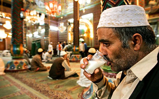A Kashmiri Muslim man prays in front of a glass of traditional drink called Sharbat, made of a mixture of milk, almond and coconut before breaking his day-long fast during Ramadan inside the shrine of a Sufi saint in Srinagar August 24, 2009. Muslims around the world abstain from eating, drinking and sexual relations from sunrise to sunset during Ramadan, the holiest month in the Islamic calendar. Fayaz Kabli/REUTERS 