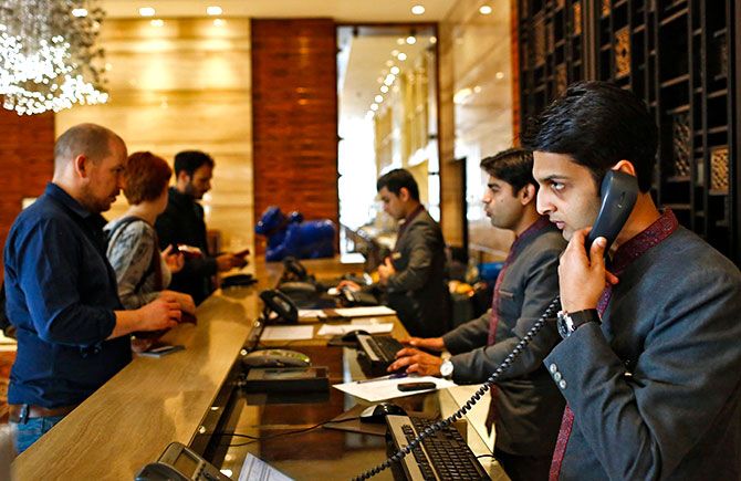 Receptionists attend to guests at the Crown Plaza hotel, run by the InterContinental Hotels Group, New Delhi, January 31, 2014. Photo: Anindito Mukherjee/Reuters