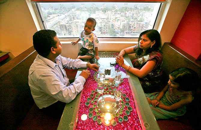 A software engineer and his family at a restaurant at Tata Group's Ginger hotel, New Delhi, May 23, 2012. Photo: Parivartan Sharma/Reuters.