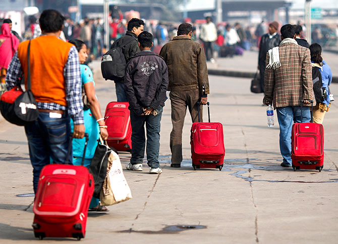 ommuters carry their luggage outside a railway station during a strike in New Delhi February 20, 2013. Photo: Adnan Abidi/Reuters 