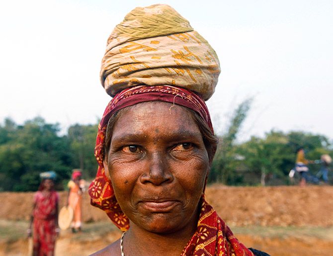 Village woman Kiran Mallick, 53, who works at a road construction site under National Rural Employment Guarantee Act. Photo: Rupak De/Reuters  