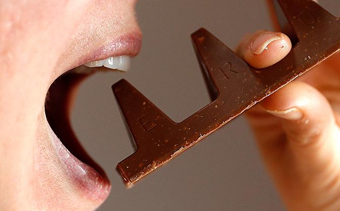 A woman poses with a 150g of Toblerone chocolate in Loughborough, Britain, November 8, 2016. Photo: Darren Staples/Reuters