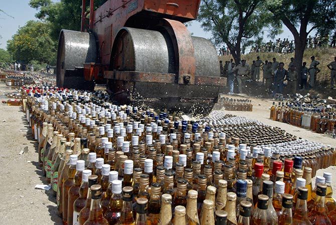 A roller crushes liquor bottles at Koba village, about 18 km (12 miles) north from the western Indian city of Ahmedabad March 28, 2006. The state prohibition department of western Indian state of Gujarat disposed of 22,000 seized bottles of liquor, an official said on Tuesday. Photo: Amit Dave/Reuters