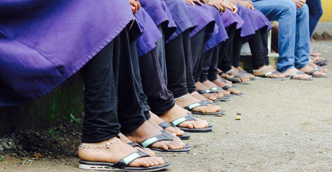 Young students show off their refurbished footwear