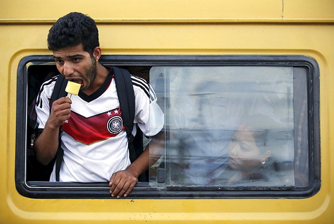 A passenger eats an ice-cream as he travels on the overcrowded bus in Nepal. Photo representational. Photo: Navesh Chitrakar/Reuters