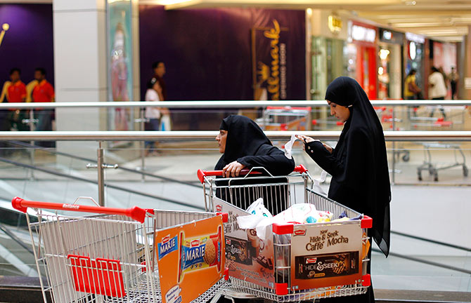 A woman checks her goods receipt outside a grocery store at a shopping mall in Mumbai July 14, 2012. Photo: Danish Siddiqui/Reuters