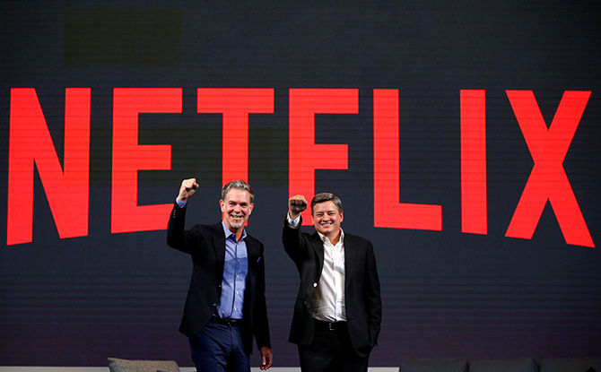 Reed Hastings, co-founder and CEO of Netflix, and Ted Sarandos, Netflix chief content officer, pose for photographs during a news conference in Seoul, South Korea, June 30, 2016. Photo: Kim Hong-Ji/Reuters