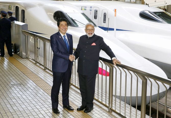 Modi and Abe pose in front of a Shinkansen bullet train. Photograph: Kyodo/via Reuters