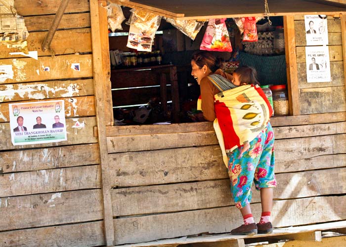 A woman buys food from a shop in Meelen village, south of the northeastern city of Imphal January 23, 2012. Photo: Rupak De Chowdhuri/Reuters 