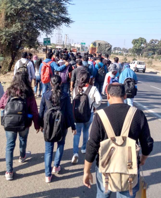 PhD and post graduate students at the Indian Institute of Technology Indore walk 18 km to the institute to highlight the withdrawal of institute buses