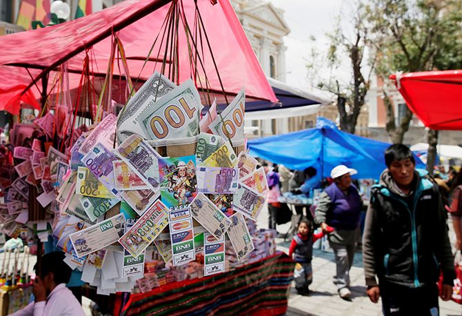 Money, credit cards and lottery replicas are on display during the "Alasita" (Buy me) fair in La Paz, Bolivia January 24, 2018. Photograph: David Mercado/Reuters.