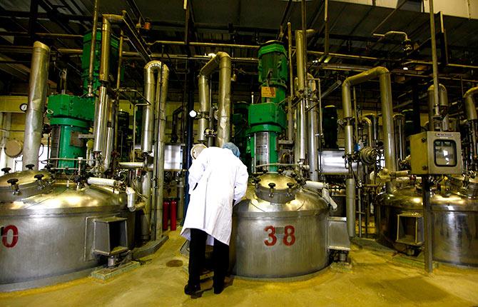 A worker for Danish biopharmaceutical company Novozymes looks at fermentation vates for producing enzymes at a factory in the Tianjin Economic Development Area (TEDA), located 120 kiolemtres south-east of Beijing May 24, 2011. Photograph David Gray/Reuters