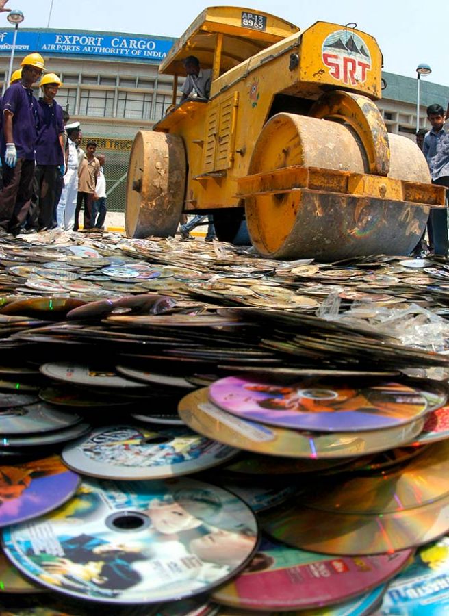 Customs officials destroy about 35,000 pirated film DVDs confiscated at the airport, in the southern Indian city of Chennai March 23, 2007. Photograph: Babu/Reuters
