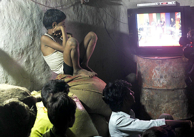 Children watch television powered by solar energy at Meerwada village of Guna district in the central Indian state of Madhya Pradesh June 18, 2012. Photograph: Adnan Abidi/Reuters