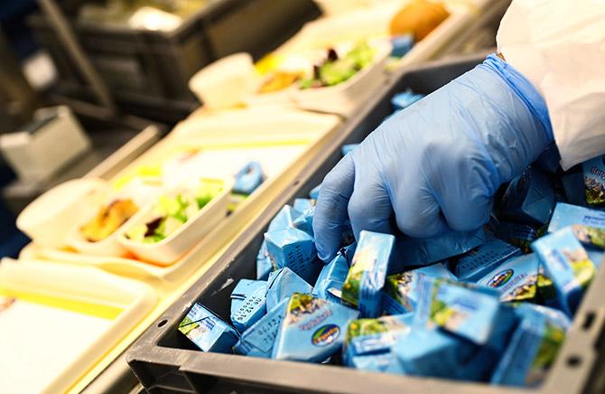 Putting together airline meals. Photograph: Kai Pfaffenbach/Reuters