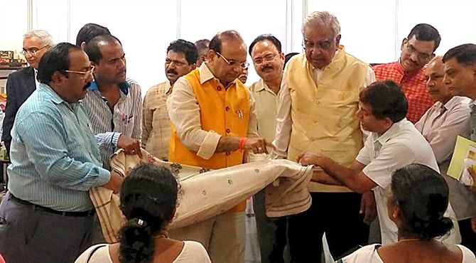 The head of KVIC VK Saxena and the head of the Indian Merchant Chambers Lalit Kanodia at a special Mumbai Khadi exhibition. Photograph: Khadi and Village Industries Commission/Facebook