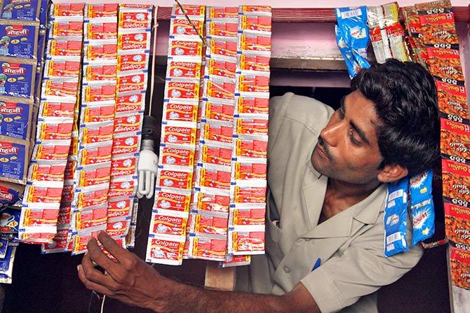 Posing with sachets of Colgate in Hargaon, Uttar Pradesh. Photograph: Pawan Kumar/Reuters