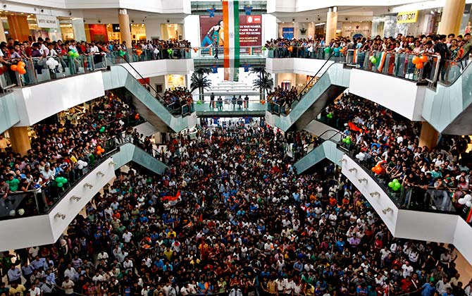 Cricket fans watch the ICC Cricket World Cup final match between India and Sri Lanka, on a big screen inside a shopping mall in Kolkata. Photograph: Rupak De Chowdhuri/Reuters