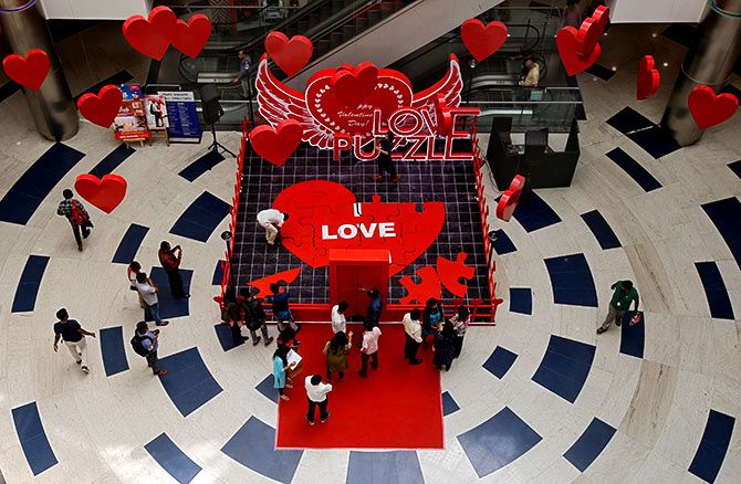 People arrange tiles of a heart-shaped puzzle during an event to promote Valentine's Day celebrations, inside a mall in Bengaluru. Photograph: Abhishek N Chinnappa/Reuters
