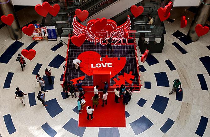 People arrange tiles of a heart-shaped puzzle during an event to promote Valentine's Day celebrations, inside a mall in Bengaluru. Photograph: Abhishek N Chinnappa/Reuters