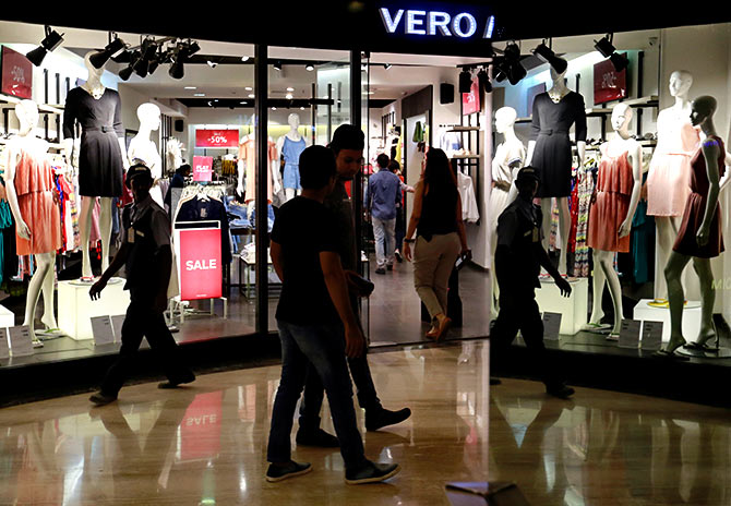 Shoppers walk past a store at a mall in Mumbai. Photograph: Danish Siddiqui/Reuters