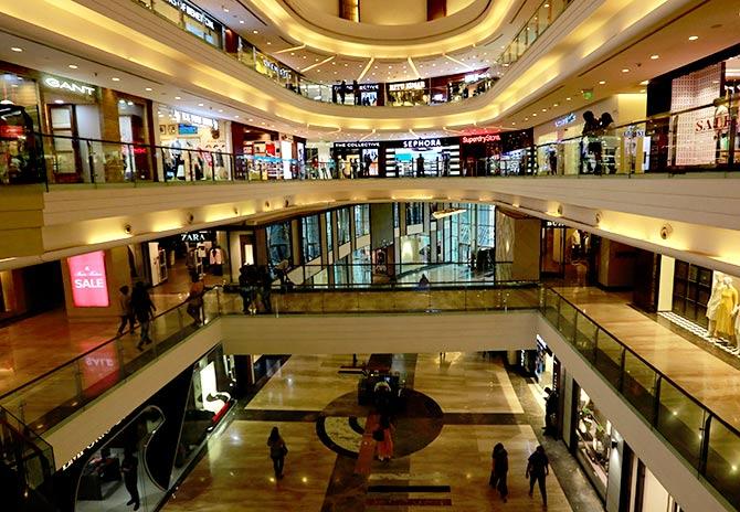 Shoppers walk past a store at a mall in Mumbai. Photograph: Danish Siddiqui/Reuters