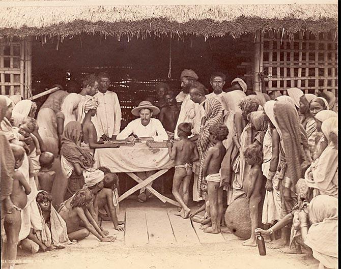 tea coolies being paid. Photograph: Courtesy Bourne and Shepherd.