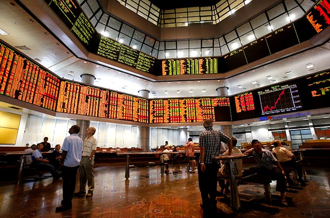 Investors monitor stock market prices in Kuala Lumpur August 16, 2013. Asian markets rode a roller-coaster on Friday, with India's rupee hitting a record low, the yuan at an all-time high and Chinese stocks roiled by a likely trading error. The jitters across Asia followed a sharp fall in Wall Street shares as signs of improvement in the U.S. job market and rising inflation stoked expectations that the Federal Reserve will reduce its stimulus next month. Photograph: Bazuki Muhammad/Reuters.