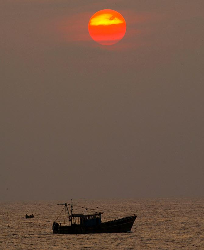 A fishing boat sits on the sea near Kovalam Beach, about 20 km (12 miles) south of Trivandrum, in Kerala. Photograph: Pawel Kopczynski/Reuters.