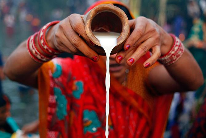 Milk being utilised in Chhath Puja. Photograph: Anindito Mukherjee/Reuters.