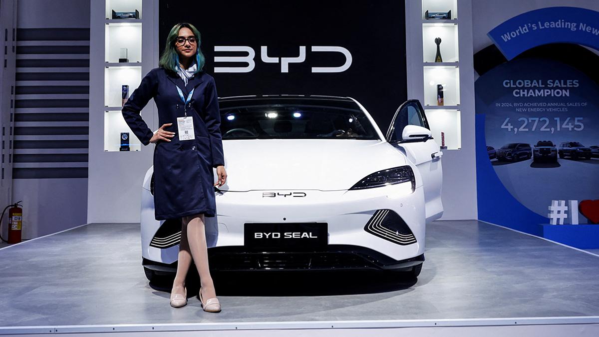 A model poses next to the BYD Seal electric vehicle