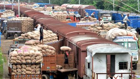 Workers unload goods train loaded with commodities Workers unload goods train loaded with commodities