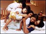 A still from Kannathil Muthamittal: Madhavan, Simran and the children