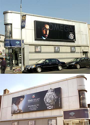 An Abhishek Bachchan billboard advertising Omega watches shares the same building as a Shah Rukh Khan billboard advertising Tag Heuer