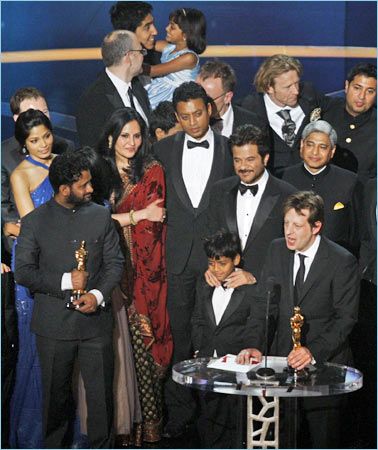 Ambassador Vikas Swarup, standing behind Anil Kapoor, as Slumdog Millionaire wins the Oscar for Best Picture