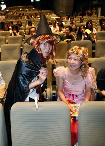 Fans in costumes pose before the screening of the world's first premiere of Harry Potter and the Half-Blood Prince in Tokyo