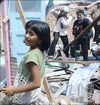 Rubina next to her home