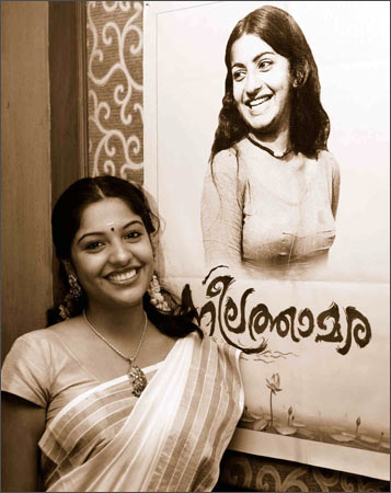 Archana with a poster of Ambika
