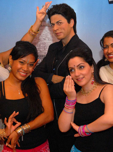 Bollywood Axion Dance Troupe perform in front of the wax figure of Shah Rukh Khan