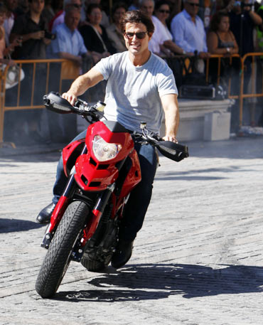 Tom Cruise rides his motorbike