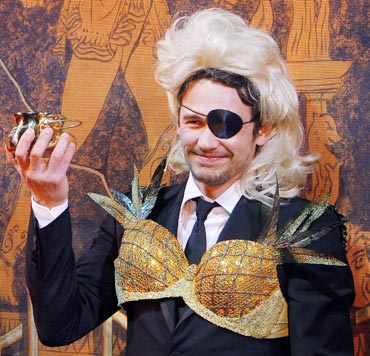 James Franco holds up his Pudding Pot award during ceremonies to honor him as Hasty Pudding Theatricals' 2009 Man of the Year at Harvard University in Cambridge, Massachusetts