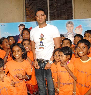 Ajay Devgn poses with school children