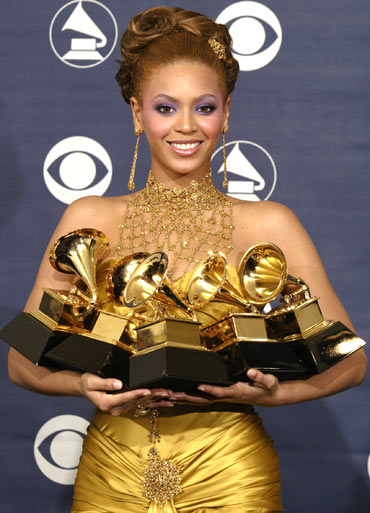Beyonce holds the five Grammy awards she won at the 46th annual Grammy Awards